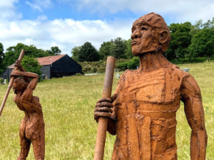 Two figures sculptures in a field